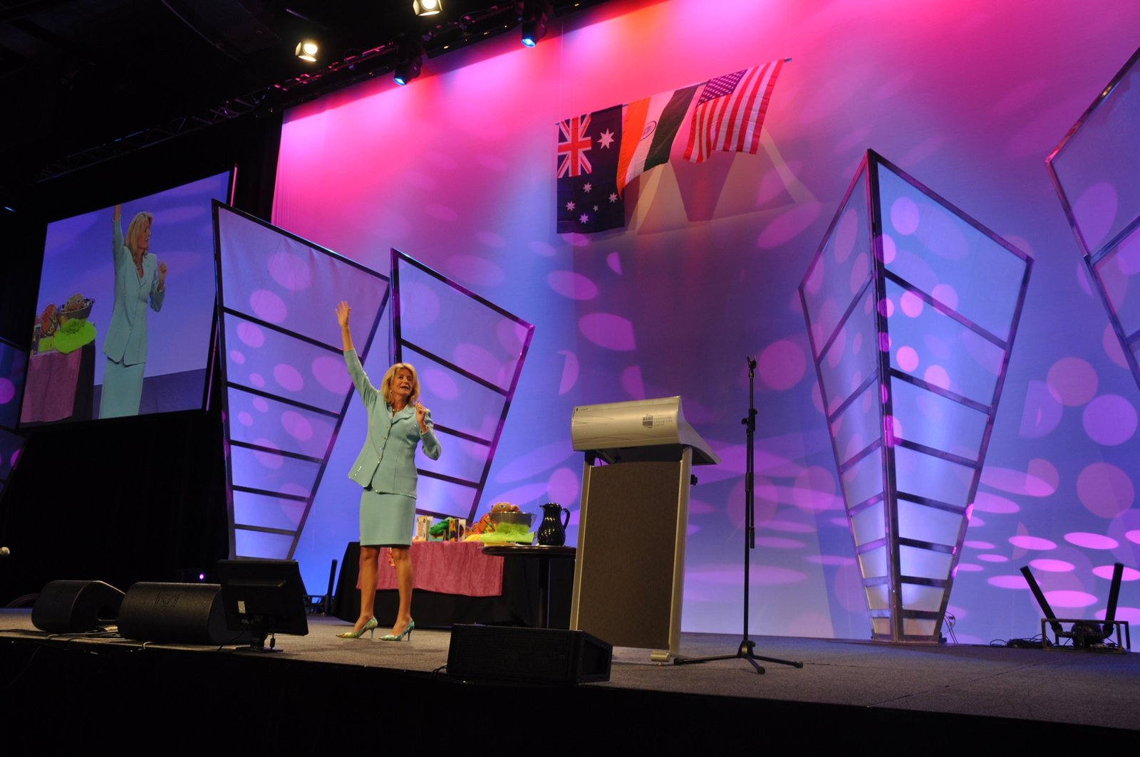 Lisa presenting on a large conference stage